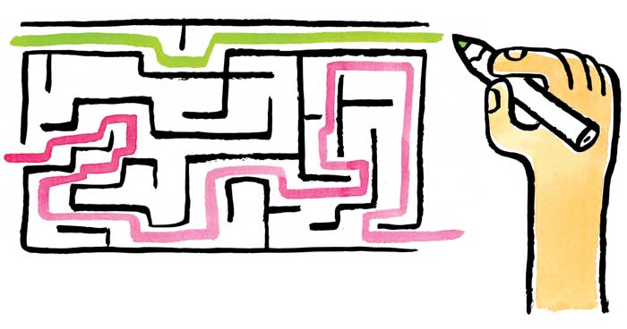 a hand drawing multiple paths through a maze