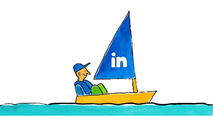 a man in a sail boat that has the LinkedIn logo on the sail